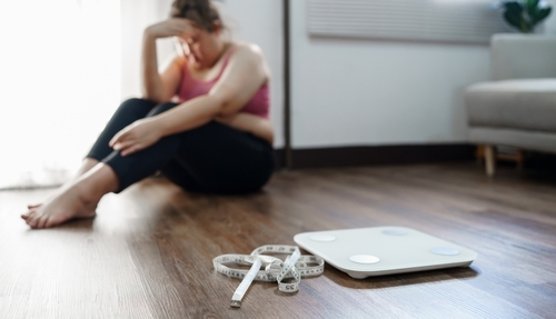 Fat woman sitting and agonizing over diet failure